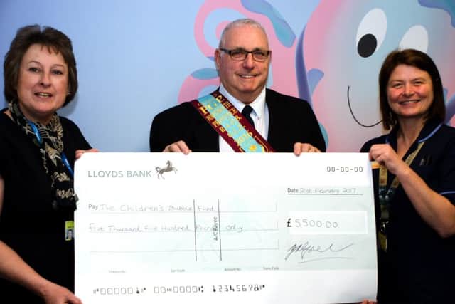 From left, head of nursing Leslie Coles, George Spencer of the Buffs and paediatric unit senior sister Tracey Thomas Picture: Irvine Forbes