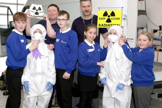 Alison Hume and Richard Aylward-Wilson of DSTL with pupils from Gomer Junior School, learning how to survive a radiation leak.Picture: Habibur Rahman (170349-57)