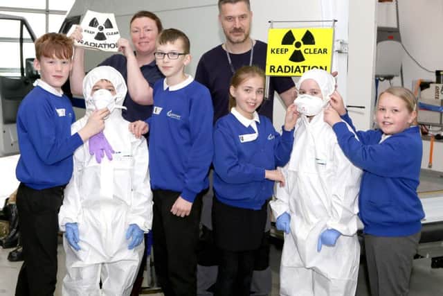 Alison Hume and Richard Aylward-Wilson of DSTL with pupils from Gomer Junior School, learning how to survive a radiation leak.
Picture: Habibur Rahman (170349-57)