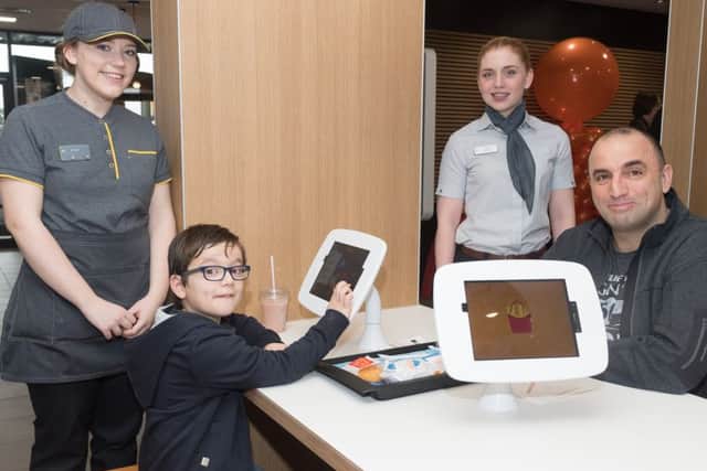 Emily Stimson, Harley Illingworth with dad Trevor, Nikki Sharratt at the McDonald's restaurant at Newgate Lane, Fareham after its refurbisment Picture: Keith Woodland (170395)