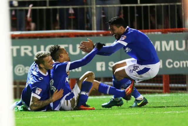Danny Rose, right, celebrates Kyle Bennett's goal against Crawley with Carl Baker Picture: Joe Pepler