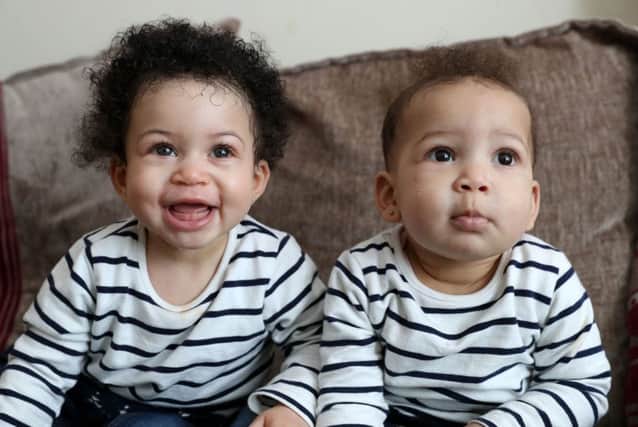 Nyobi, left, and Kenya, daughters of Tracy and Pete Akoun, who were born a month apart to two different lesbian surrogate mothers, at home in Portsmouth Picture: Andrew Matthews/PA Wire