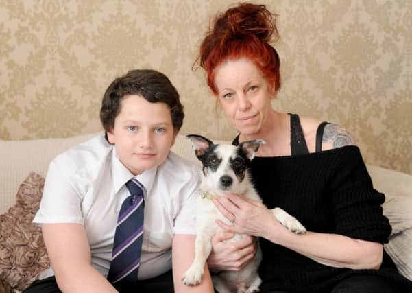 Bex Dann, 45, with her son Logan Dann-Kirby, 14, and their other dog Zorro, a 13-year-old Jack Russell cross 

Picture: Sarah Standing (170282-3606)