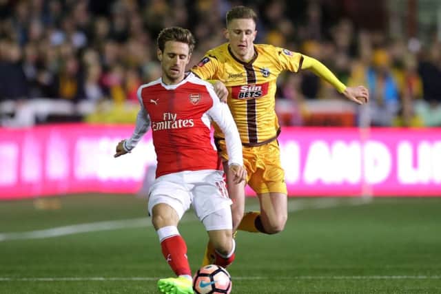 Adam May in action for Sutton against Arsenal
