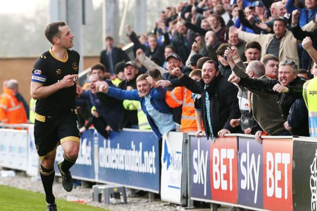 Michael Doyle celebrates his goal with the Pompey fans. Picture: Joe Pepler