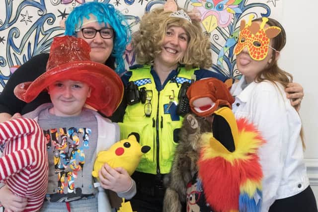 Ethan Nash with mum Maria, PCSO Amanda Turner, Lloyd Hill (under all the toys) and Courtney Nash Pictures: Keith Woodland (170398)