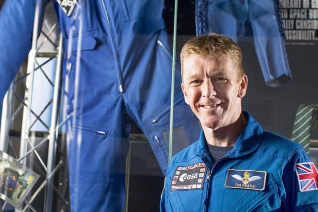 Tim Peake standing next to the suit he wore in space which was donated to the exhibition at The Novium Museum in Chichester, which is up for an award