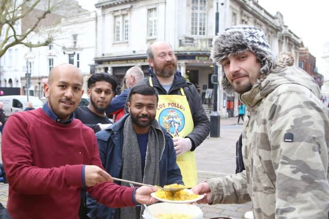 Forhad and Jaf Ahmed from The Akash with Don't Hate, Donate's Abdul Kahir and David Sekules serving food to Russell Allen Picture: Habibur Rahman (170352-93)
