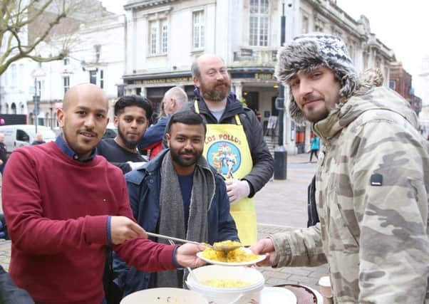 Forhad and Jaf Ahmed from The Akash with Don't Hate, Donate's Abdul Kahir and David Sekules serving food to Russell Allen Picture: Habibur Rahman (170352-93)