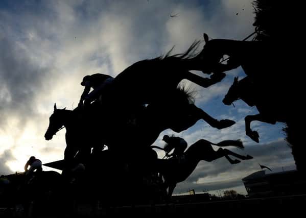 Runners and riders compete in the 16:50 JT McNamara National Hunt Challenge Cup Amateur Riders' Novice Chase during Champion Day of the 2017 Cheltenham Festival at Cheltenham Racecourse. Photo credit should read: David Davies/PA Wire. PPP-170315-121919001