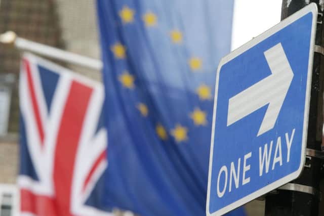 File photo dated 10/03/17 of a road traffic sign in front of the Union Jack and the European Union flag hanging outside Europe House in Smith Square, London. The Queen will sign the Article 50 Bill into law on Thursday, clearing the way for Theresa May to formally start talks to leave the European Union. PRESS ASSOCIATION Photo. Issue date: Wednesday March 15, 2017. See PA story POLITICS Brexit. Photo credit should read: Yui Mok/PA Wire POLITICS_Brexit_065900.JPG