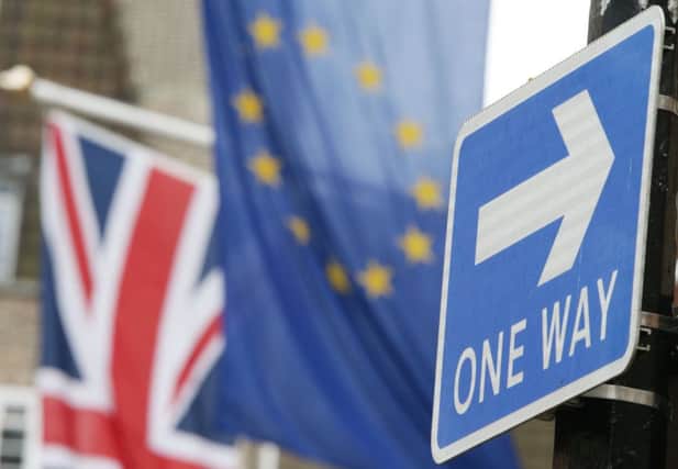 File photo dated 10/03/17 of a road traffic sign in front of the Union Jack and the European Union flag hanging outside Europe House in Smith Square, London. The Queen will sign the Article 50 Bill into law on Thursday, clearing the way for Theresa May to formally start talks to leave the European Union. PRESS ASSOCIATION Photo. Issue date: Wednesday March 15, 2017. See PA story POLITICS Brexit. Photo credit should read: Yui Mok/PA Wire POLITICS_Brexit_065900.JPG