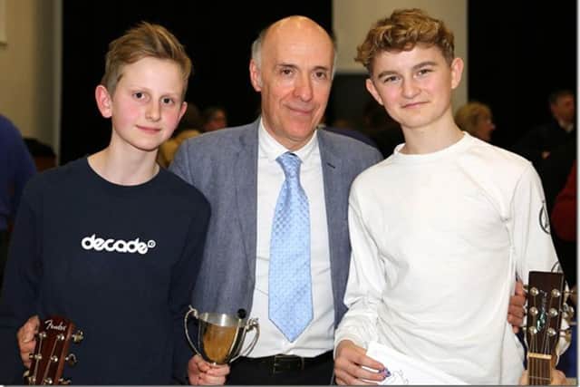 Adjudicator Carlos Bonell, centre, with cup winners Ollie Searle and Finn Fleming