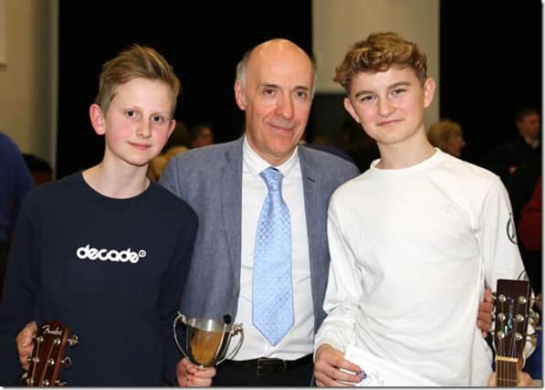 Adjudicator Carlos Bonell, centre, with cup winners Ollie Searle and Finn Fleming