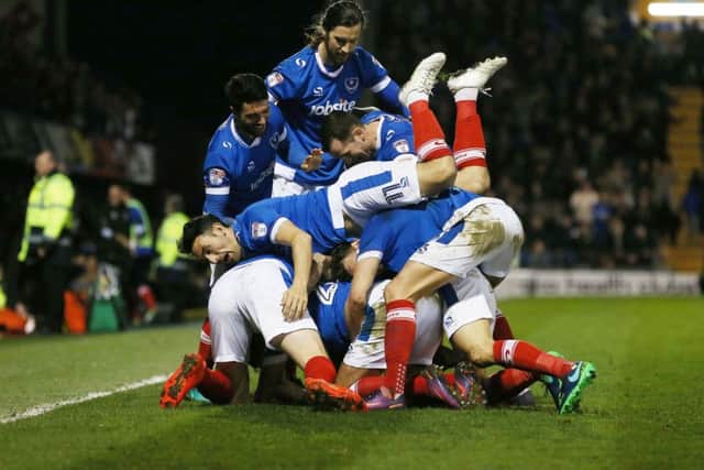 The Pompey players celebrate Carl Baker's goal against Grimsby on Tuesday night Picture: Joe Pepler