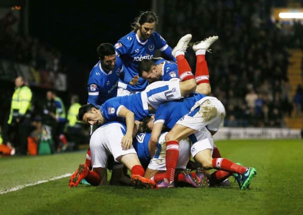 The Pompey players celebrate Carl Baker's goal against Grimsby on Tuesday night Picture: Joe Pepler