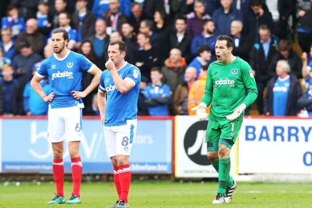 David Forde shouts orders at Christian Burgess and Michael Doyle during Pompey's 3-0 loss to Stevenge: Joe Pepler