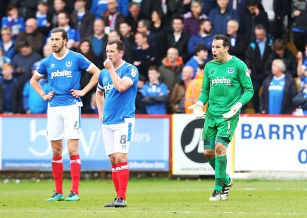 David Forde shouts orders at Christian Burgess and Michael Doyle during Pompey's 3-0 loss to Stevenge: Joe Pepler