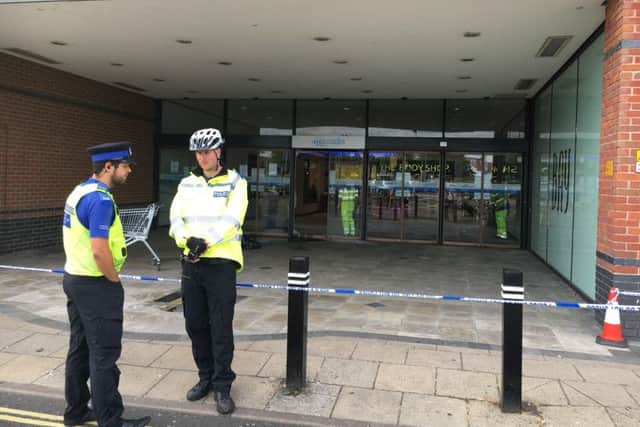 Pictured: Workers clean up the remains of a fire in Charlotte Street after a raid at a jewellery store. Thieves raided Ernest Jones in Cascades Shopping Centre in Portsmouth on July 26. Picture: Ben Fishwick PPP-160726-142059001
