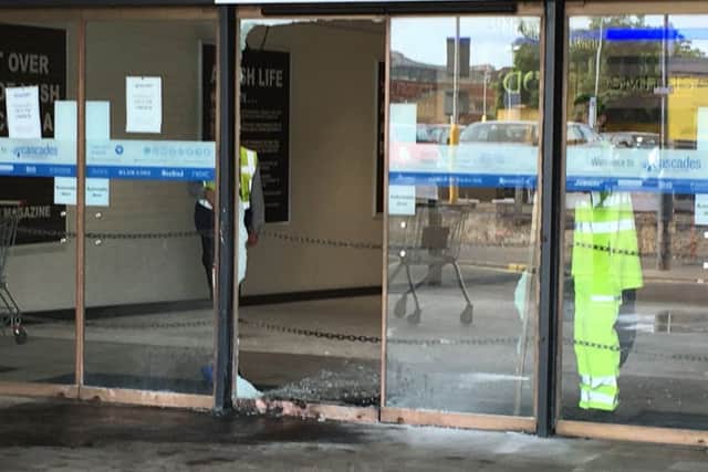 Pictured: Workers clean up the remains of a fire in Charlotte Street after a raid at a jewellery store. Thieves raided Ernest Jones in Cascades Shopping Centre in Portsmouth on July 26. Picture: Ben Fishwick PPP-160726-142146001