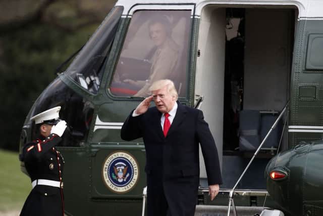 President Donald Trump salutes as he steps off Marine One at the White House, Sunday, March 19, 2017, in Washington. Trump is returning from a trip to his Mar-a-Lago estate in Palm Beach, Fla. (AP Photo/Alex Brandon)