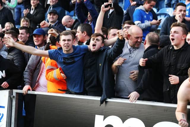Pompey fans celebrate the recent win at Colchester Picture: Joe Pepler