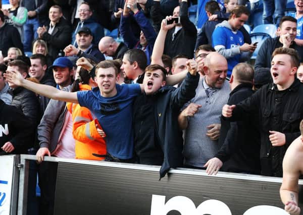 Pompey fans celebrate the recent win at Colchester Picture: Joe Pepler