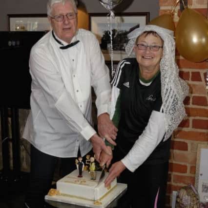Angus and Margaret McGilp, who celebrated their 50th wedding anniversary, cutting the cake presented to them by the park run organisers.  Picture: Neil Marshall (170289-14)
