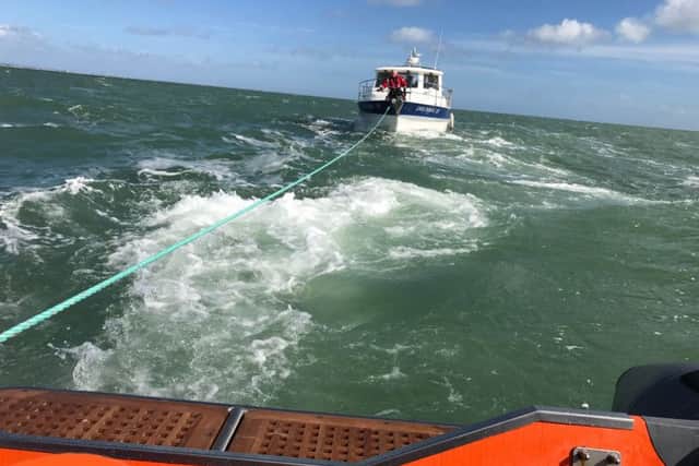 The Gafirs crew pulls the cabin cruiser to safety
