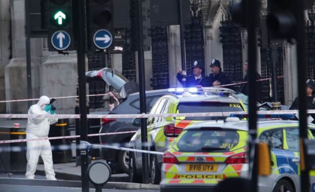 Police forensic officers close to the Palace of Westminster, London, after an attack earlier today. Picture: Yui Mok/PA Wire