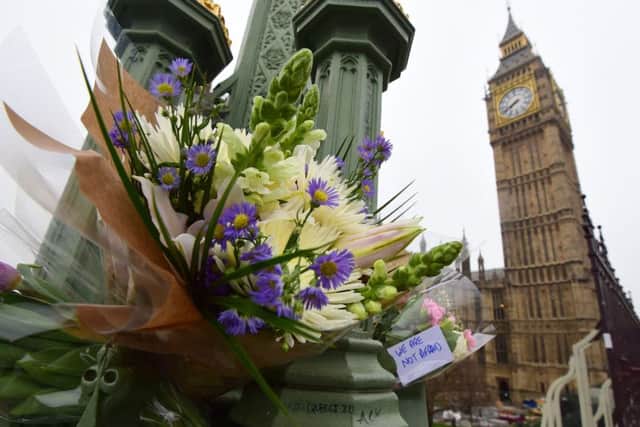 Flowers left on Westminster Bridge in central London following the terrorist attack on Wednesday which claimed the lives of four innocent victims. PRESS ASSOCIATION Photo. Picture date: Friday March 24, 2017. See PA story POLICE Westminster. Photo credit should read: Lauren Hurley/PA Wire POLICE_Westminster_074350.JPG