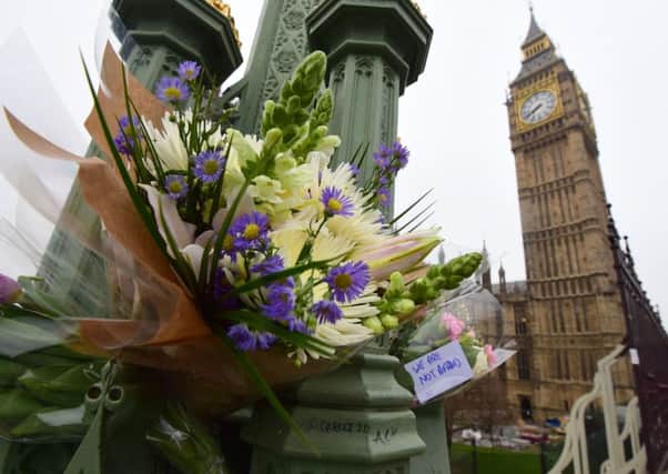 Flowers left on Westminster Bridge in central London following the terrorist attack on Wednesday which claimed the lives of four innocent victims. PRESS ASSOCIATION Photo. Picture date: Friday March 24, 2017. See PA story POLICE Westminster. Photo credit should read: Lauren Hurley/PA Wire POLICE_Westminster_074350.JPG