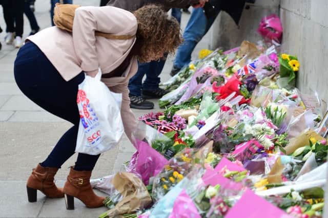 A wellwisher lays flowers outside the Houses of Parliament Picture: Lauren Hurley/PA Wire