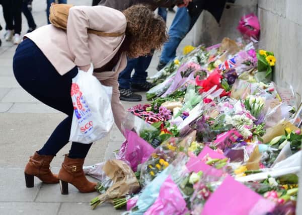 A wellwisher lays flowers outside the Houses of Parliament Picture: Lauren Hurley/PA Wire
