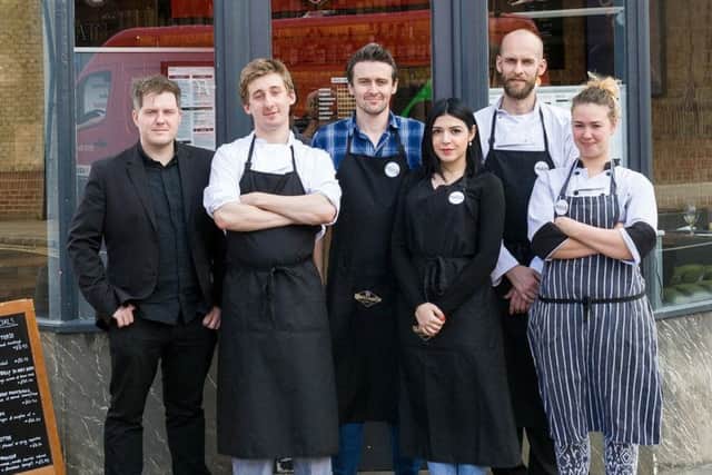 The staff of Huis outside the bar