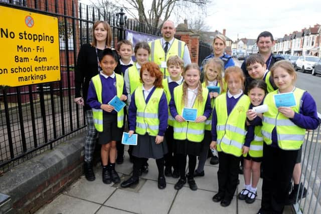 Back from left, physical social health education manager Chantelle Knight, senior civil enforcement officer Bradley Bee,  PCSO Susan Smith and civil enforcement officer Ian Maund, with the junior road safety officers from Wimborne Junior School Picture: Sarah Standing (170401-4316)