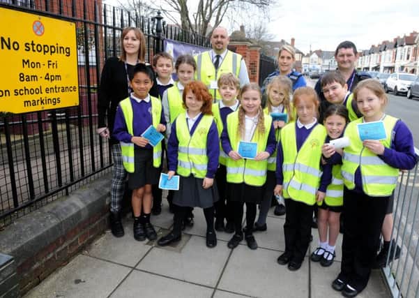 Back from left, physical social health education manager Chantelle Knight, senior civil enforcement officer Bradley Bee,  PCSO Susan Smith and civil enforcement officer Ian Maund, with the junior road safety officers from Wimborne Junior School 

Picture: Sarah Standing (170401-4316)