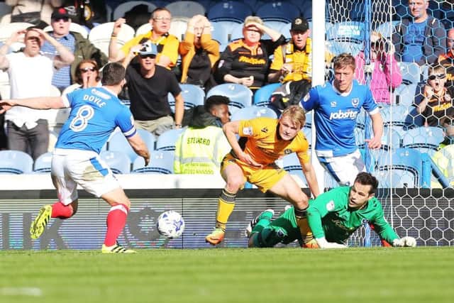 Michael Doyle, left, rushes to mop up a goalmouth scramble in the Pompey penalty area Picture: Joe Pepler