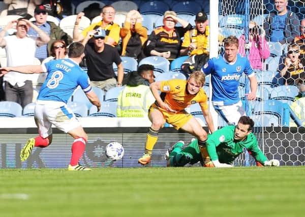 Michael Doyle, left, rushes to mop up a goalmouth scramble in the Pompey penalty area Picture: Joe Pepler