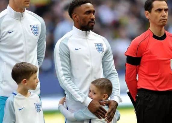Bradley hugs Jermain Defoe before the match