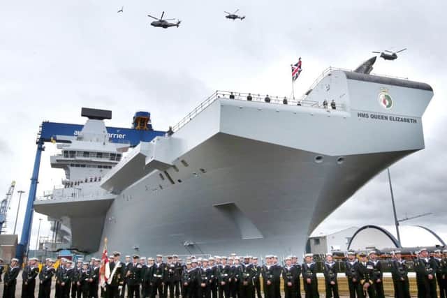A helicopter flypast at the formal naming ceremony for HMS Queen Elizabeth in Rosyth Dockyard, Fife Picture: Andrew Milligan/PA Wire