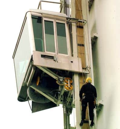 Technicians work on the Spinnaker Tower's lift in October 2005. Picture: Michael Scaddan