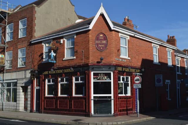 The Electric Arms, Fratton Road, Fratton: the electrician depicted on the sign is holding a pint of beer in one hand and an electric cable in the other.