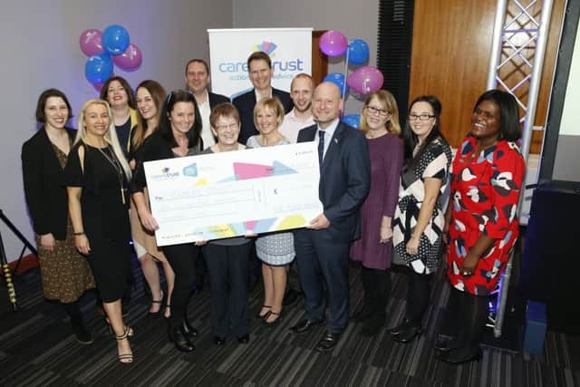 Company representatives and charity champions with the £1.5m cheque