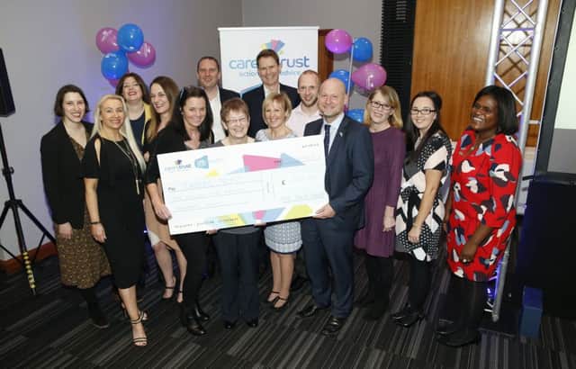 Company representatives and charity champions with the Â£1.5m cheque