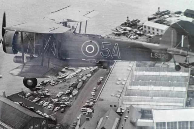 The last Fairey Swordfish flying low over Gosport in the early 1960s in a picture from the Richard Hulse Collection.