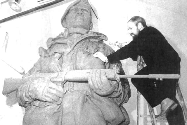 Philip Jackson applies the finishing touches to the towering clay model (9221-1)