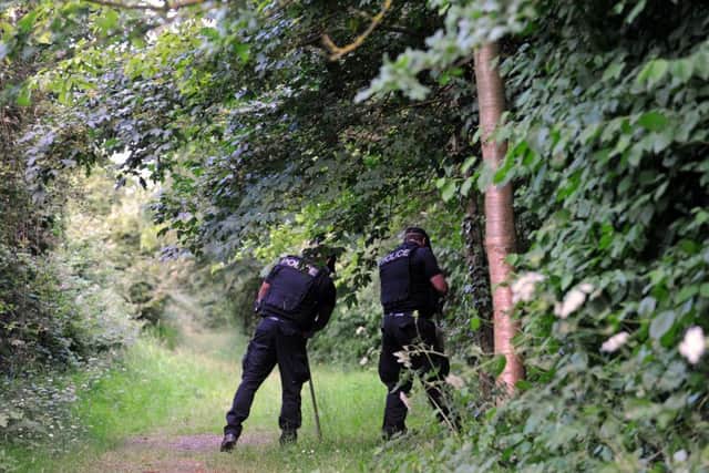 Police searcing woods in Hilsea Lines in Portsmouth where a woman was stabbed