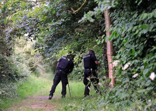 Police searcing woods in Hilsea Lines in Portsmouth where a woman was stabbed