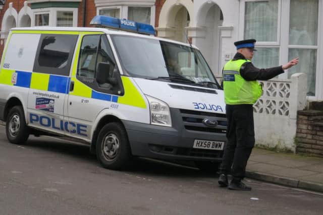 Police in Percy Road after they shut an alleyway between Fawcett Road and Talbot Road